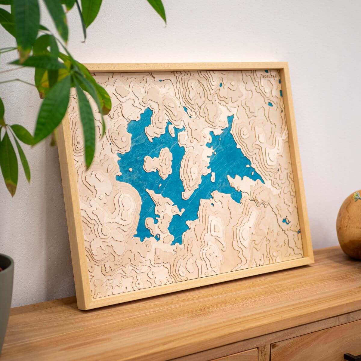 Carte du lac de Vassivière posée sur une commode d'entrée en bois