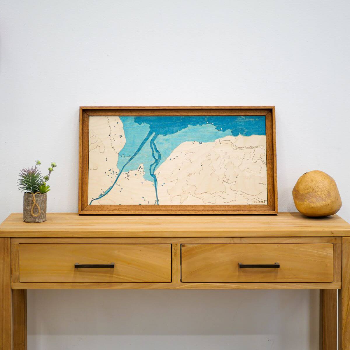 Carte de la baie des Veys en relief posée sur une commode en bois